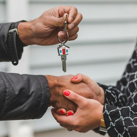 person holding silver key