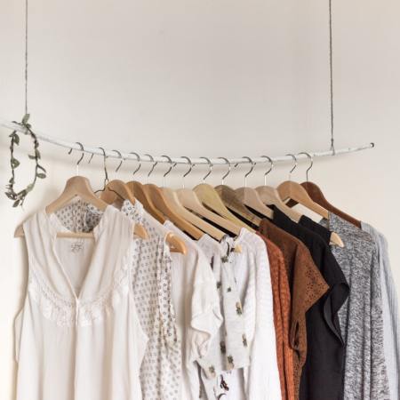 clothing rack of quiet luxury shirts and sweaters
