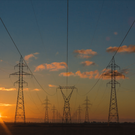 Cinematic view of power lines and energy infrastructure highlighting costs for energy consumers